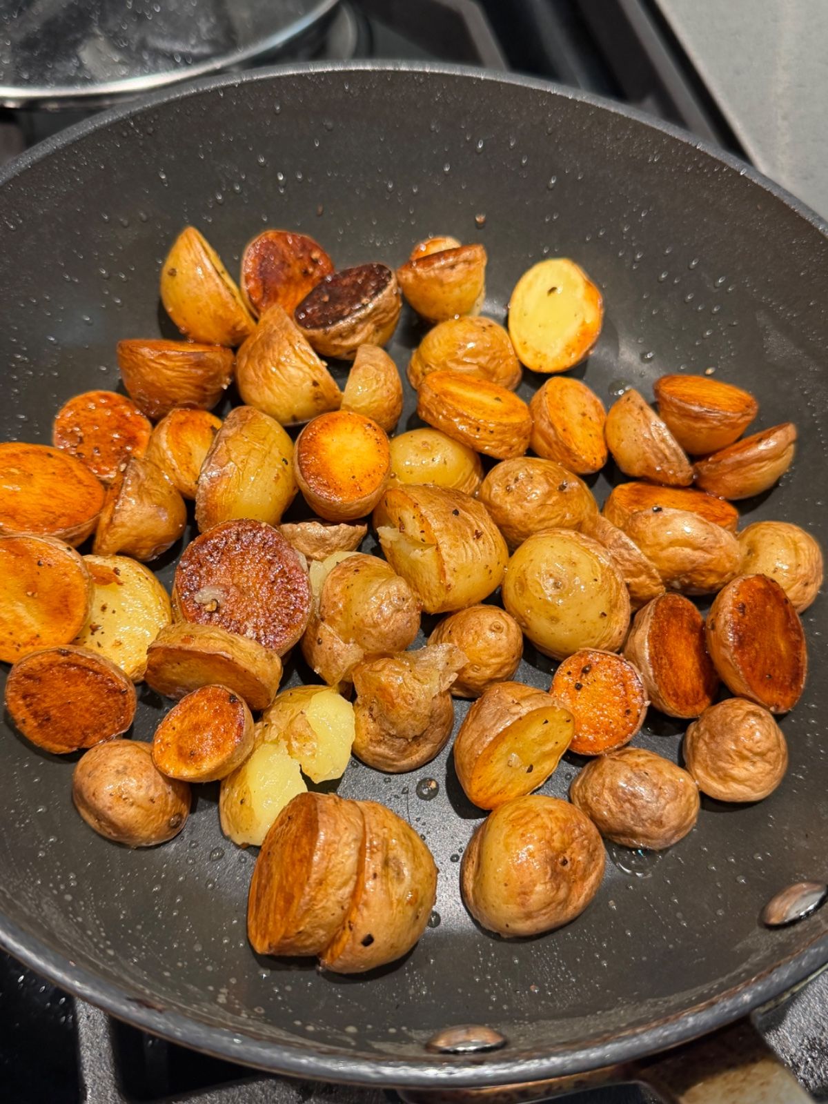 Baby potatoes, cut side down, with deep golden restaurant-grade crust.